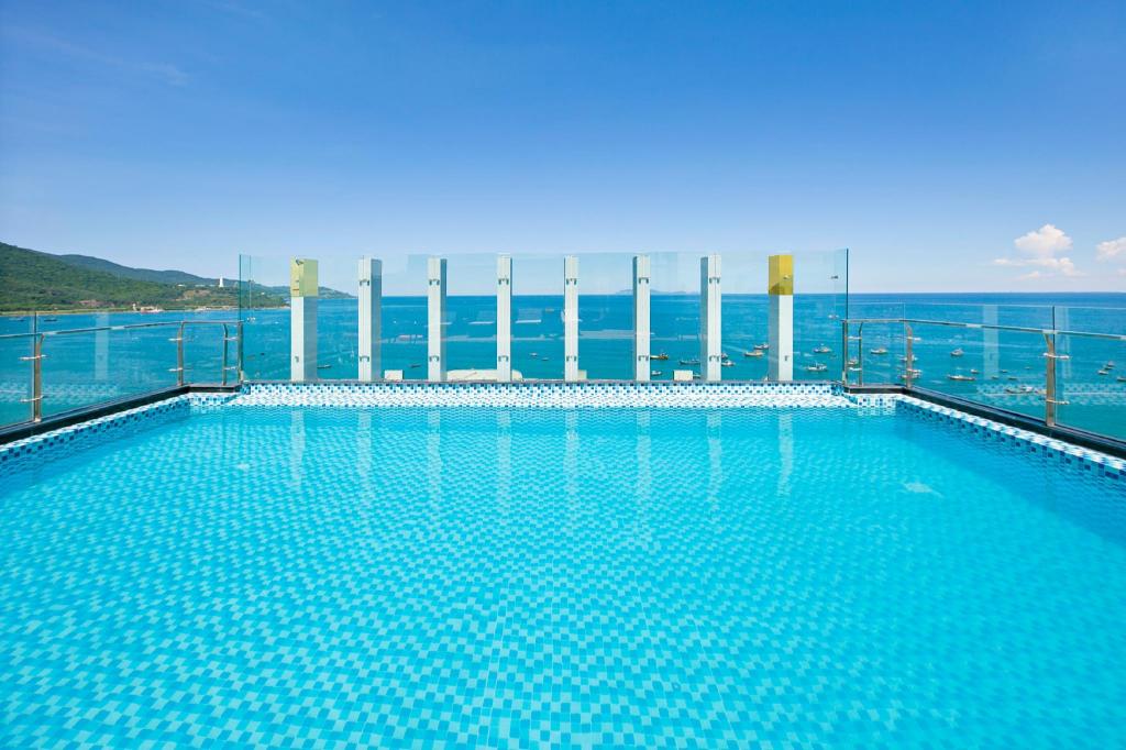 Outdoor pool at Alisia Beach Hotel with bar stools set in the water