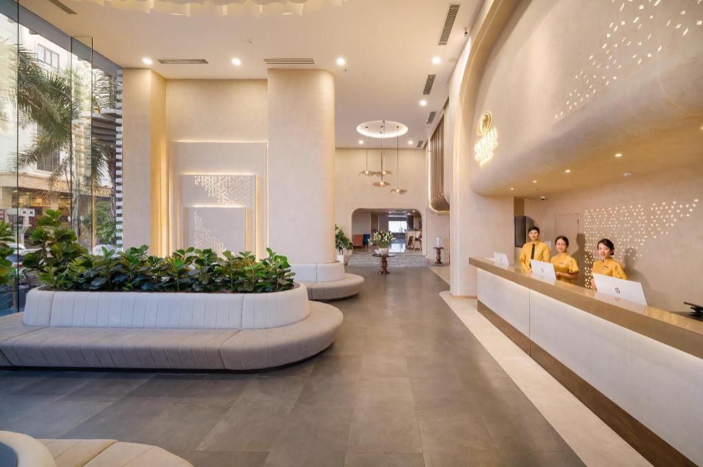 Reception desk at Cicilia Danang Hotels & Spa, with the Cicilia logo on the front