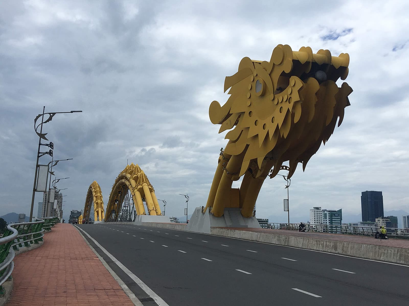 The Dragon Bridge over the Han River in Da Nang, shaped as a dragon, seen from the riverbank