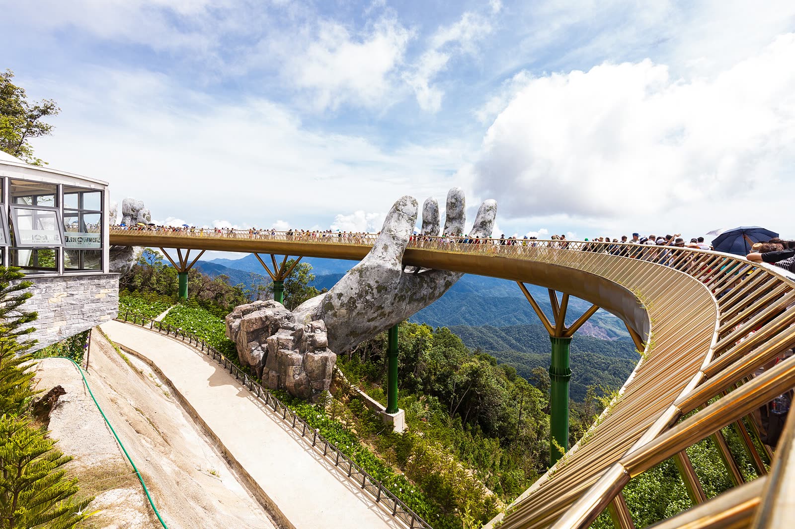 The Golden Bridge, included in the ₫1,000,000 adult ticket. Photo: Supanut Arunoprayote, Wikimedia Commons, CC BY 4.0 The Golden Bridge at Ba Na Hills, a gold walkway held up by two giant stone hands above the forest
