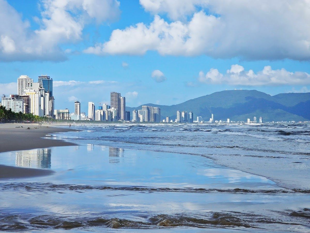My Khe Beach in Da Nang with the city skyline and mountains in the background
