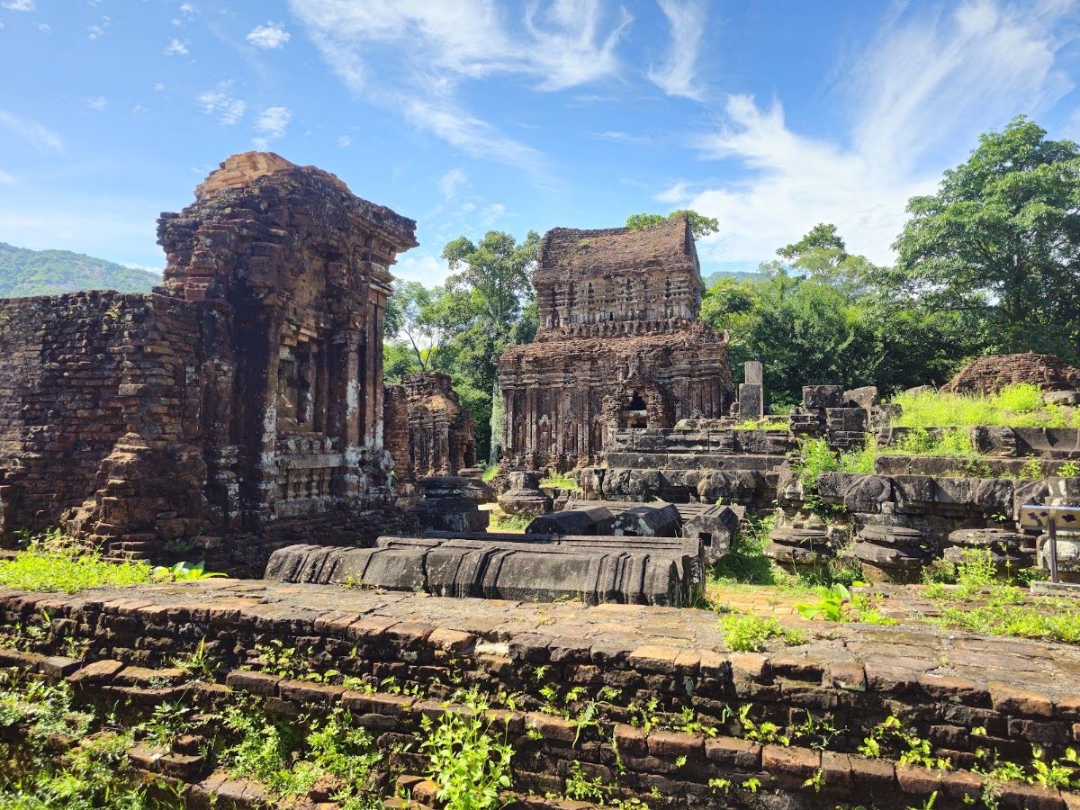Ancient Cham tower ruins at My Son Sanctuary surrounded by dense jungle
