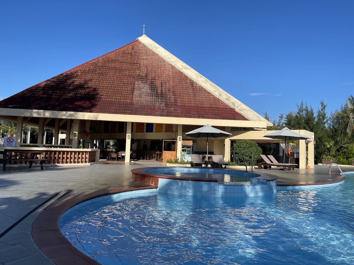 Non Nuoc beach resort pool area with traditional Vietnamese pavilion and blue sky Da Nang